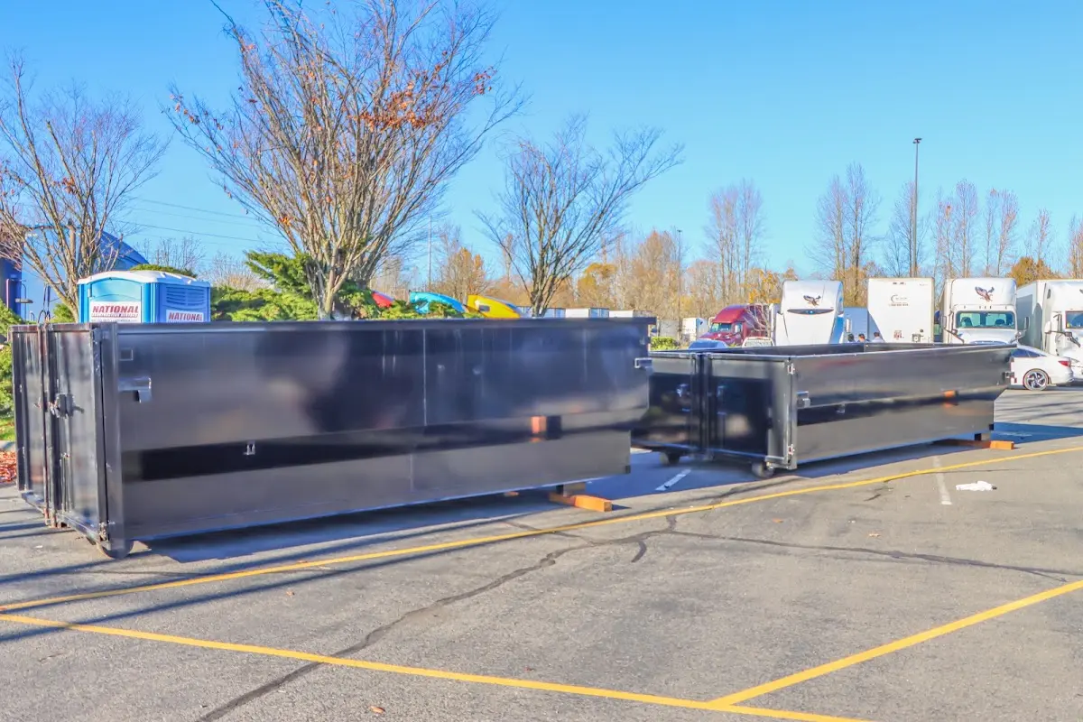 Professional dumpster rental service with roll-off container on residential driveway in Leesburg